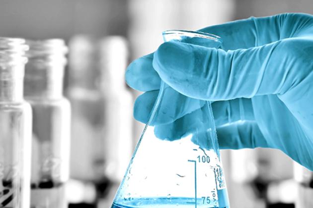 Lab tech holding a beaker