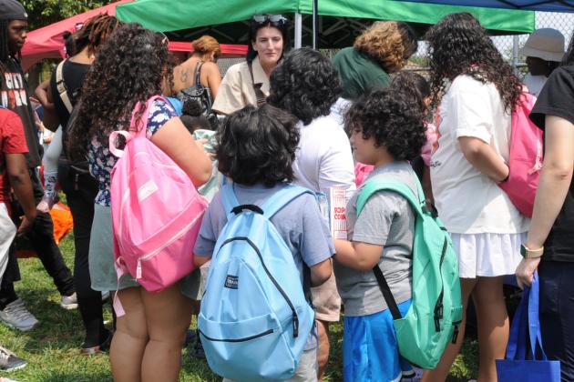 Children gather around and interact with one another while wearing new backpacks that were given away to them at the UFT's annual backpack giveaway and barbecue on Aug. 7.