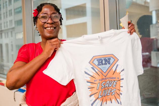 School nurse Patricia Theodore of PS 46 in Brooklyn’s T-shirt bursts with union pride: "My superpower is I save lives."