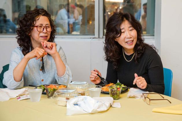 Queens school nurses — and first-time event attendees — Miyoung Kim-Vogel (left) of the District 25 Pre-K Centers and Hyeyoung Lee of PS 31 engage with others over the meal.