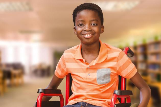 Young boy in a wheelchair in a library