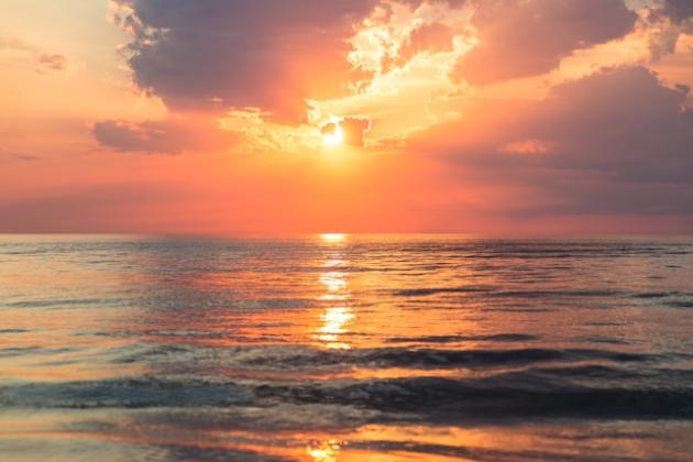 Sun setting over the ocean horizon