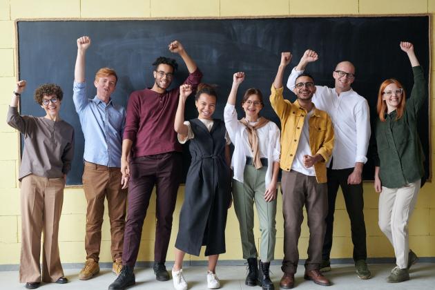 teachers with hands in air - chalkboard - generic