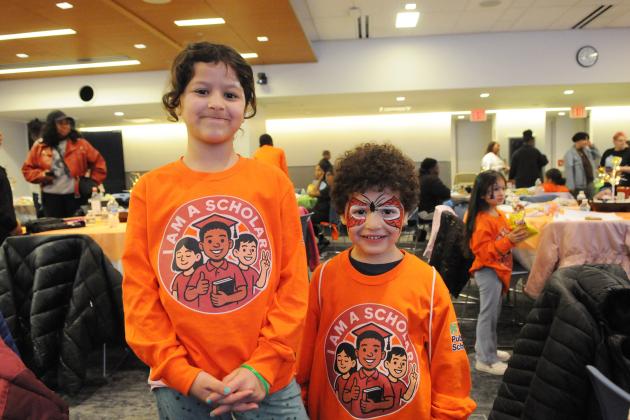 A pair of siblings, ages 8 and 5, show off their face paint and shirts before having lunch.