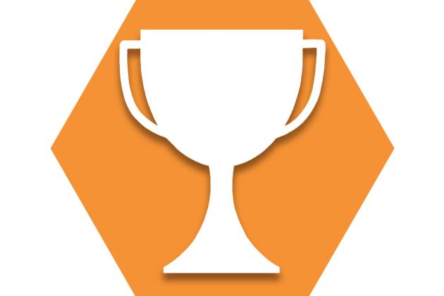 Orange hexagon with outline of a trophy