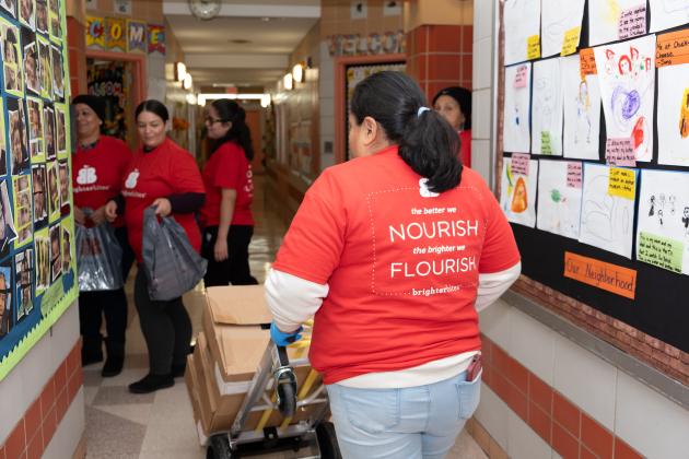 Parent volunteers at Manhattan’s PS 4 in Washington Heights prepare boxes and bags to be loaded with healthy produce.