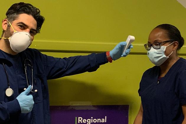 Male and female nurse wearing PPE