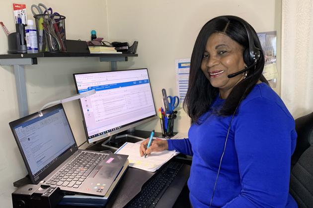 Nurse sitting at desk in front of computer