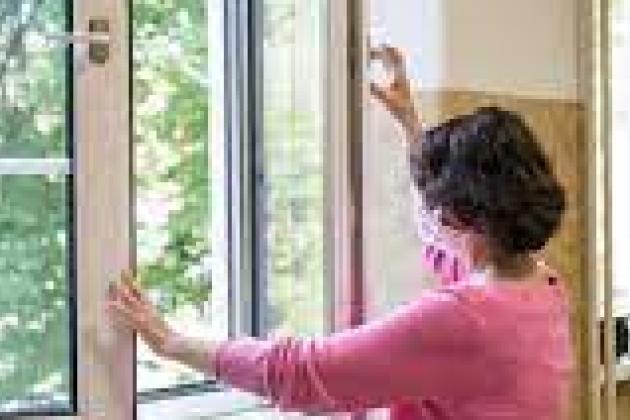 A teacher opening a window