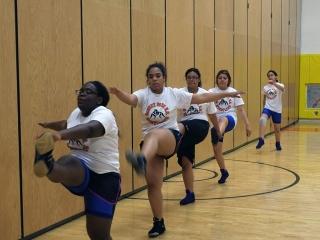 Warming up with some “Frankenstein walks,” part of a routine that includes forwa