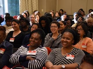 Members enjoy a light moment during a panel about the politics of health care at