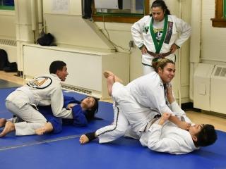 Under coach Michelle Colon’s watchful eye, team members grapple in pairs.
