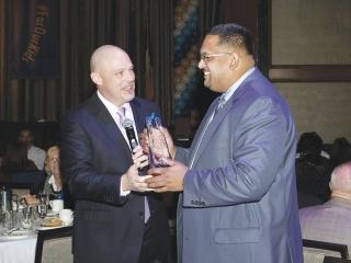 Mulgrew congratulates David Doorga, the chapter leader at PS 168, a District 75 