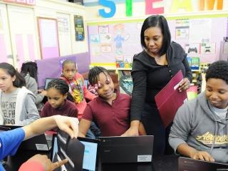 Paraprofessional Lanaya Bellamy helps students at PS 314 in the South Bronx. 