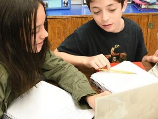 Two students discuss what they have learned about labor leader Samuel Gompers an