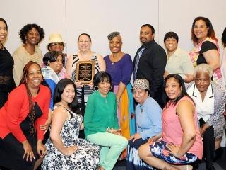 Manhattan Secretary of the Year Adina Delgado (center, holding plaque) with her 