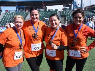 UFT members show off their medals for completing the 5K at Coney Island.