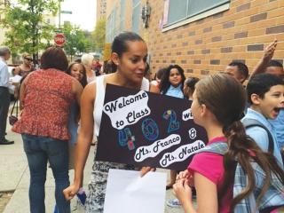 Teacher Jessica Franco greets students at PS 178 in Washington Heights.