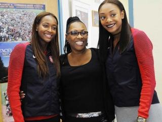It’s a happy reunion for (from left) Dalilah Muhammad, DeVore and Stevens.