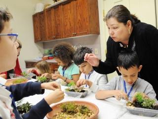 Gently, gently, teacher Nancy Ioannou advises her gardeners.