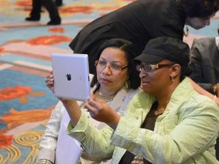 Two participants in the Digital Tools workshop try their hand at a “selfie.”