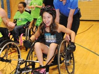 A student tries out a racing wheelchair.