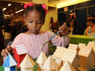 Amanda, 8, paints a little birdhouse during the event.