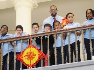 PS 149 music teacher Will Mosley and his students view the ceremony from the bal