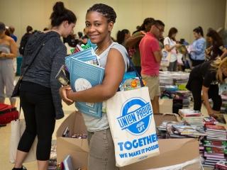 Toni Frank, a secretary at PS 208 in the Bronx, has her arms full of books.