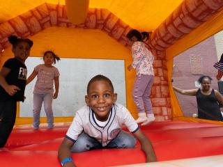 Children enjoy the bounce house at the family event.
