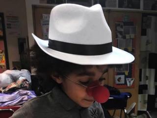 A student uses her costume to help act out a Spanish picture book.