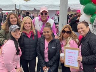 A group of marchers wearing pink pose for a photo