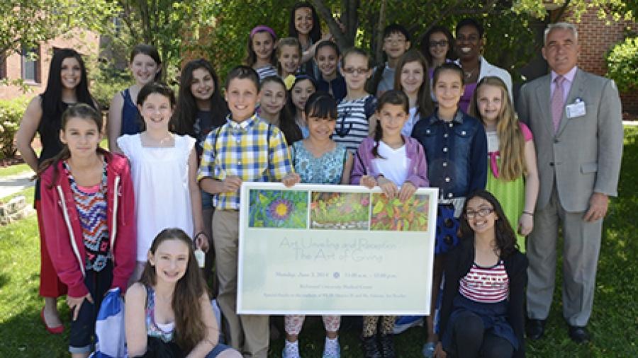Students get together for a group shot with PS 50 Assistant Principal Erika Desiano