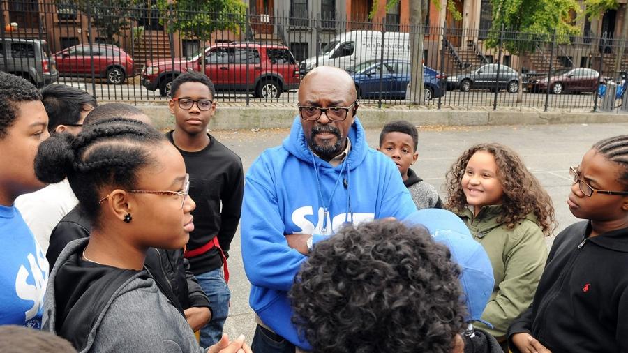 The PS/MS 282 flag rugby players get instructions from Coach Zebulon Alexander.