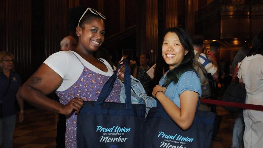 Two women pose for a photo at a new teacher event 