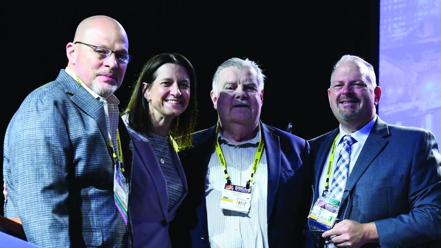 Tom Murphy stands with two other men and a woman