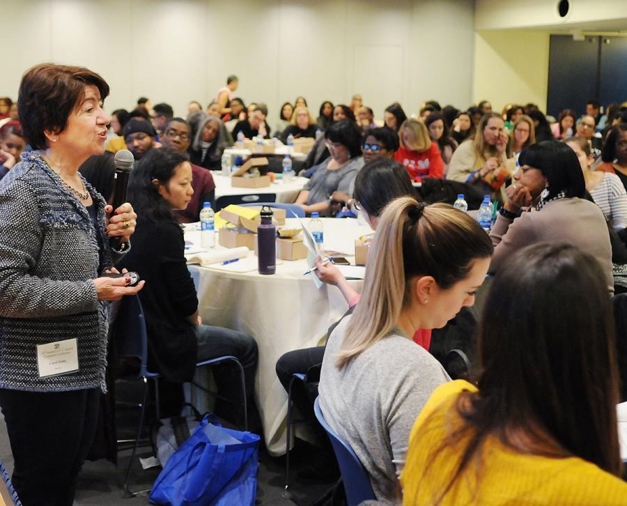 Dr. Carol Dahir (standing) delivers a keynote address about new statewide school counseling regulations.
