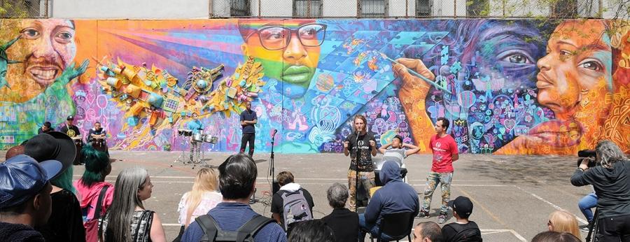 The founders of Artolution speak as the mural is presented.