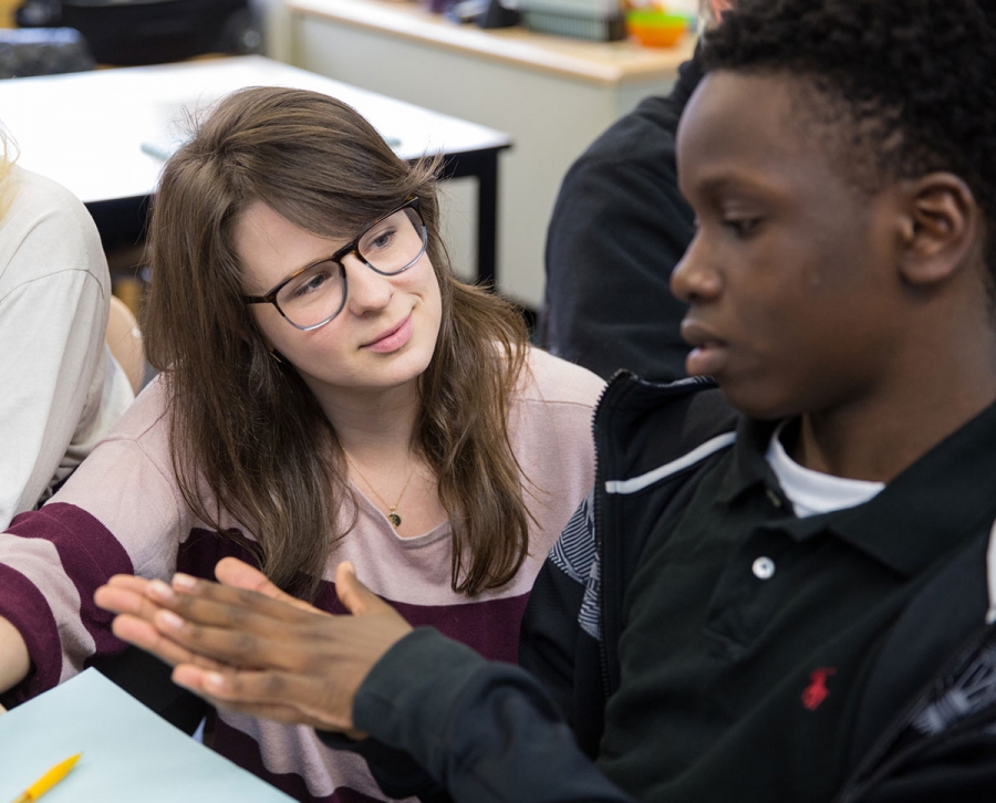 English teacher Katherine Clark (center) helps prepare a student for the difficu