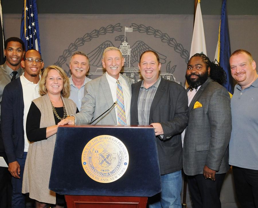 Mohr (fifth from right) is joined at the podium by Pathways to Graduation collea