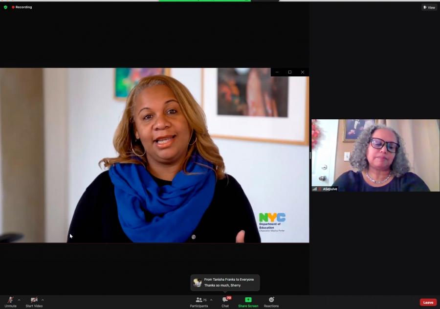 Two woman connect on a virtual meet while one wearing a blue scarf is talking.