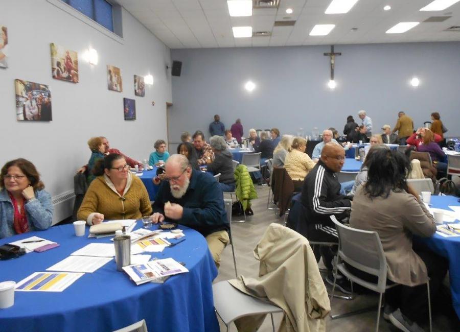 People sitting at tables in a conference room