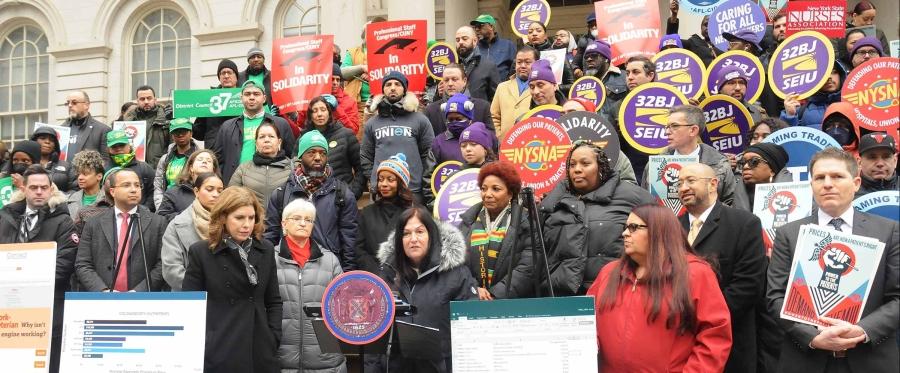 Protesters stand outside City Hall