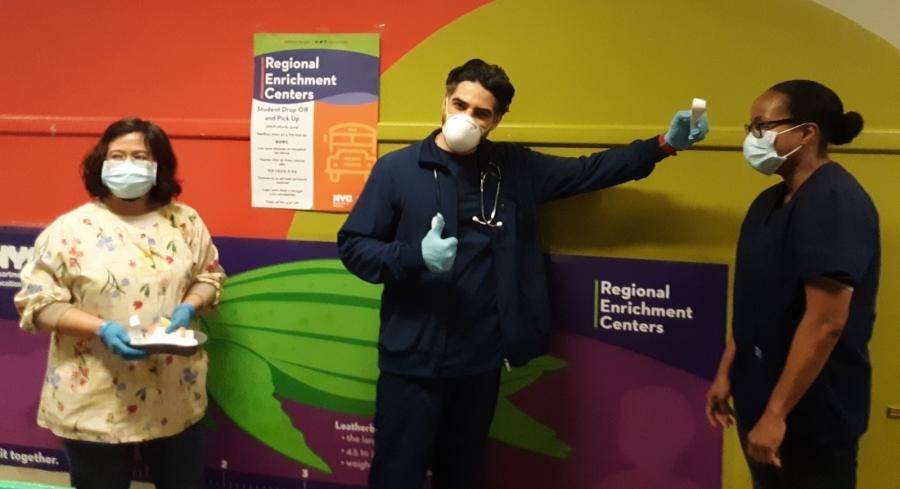 Three school nurses in PPE at a NYC school enrichment center