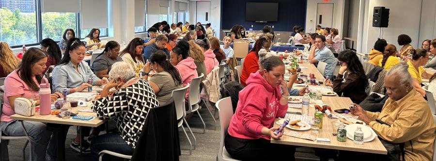 People sitting at a table looking at bingo cards