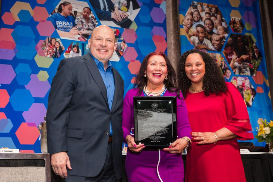 Marizol Rizol (center), the Humanitarian Award recipient, is flanked by UFT President Michael Mulgrew and UFT Paraprofessionals Chapter Chairperson Priscilla Castro at the UFT Paraprofessional Awards Luncheon on March 7, 2026. 