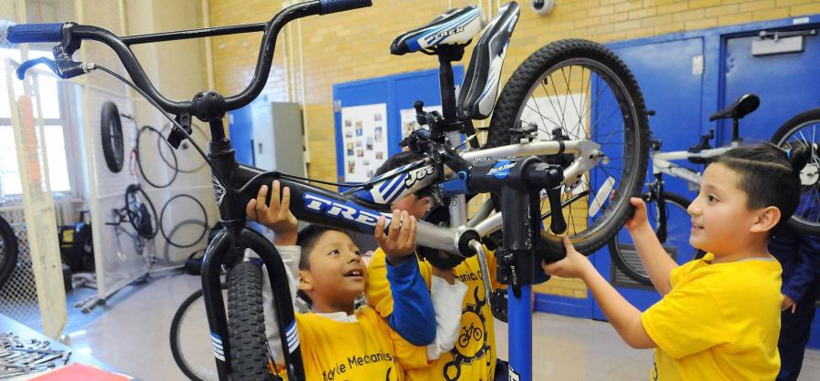 Two boys repair a bike