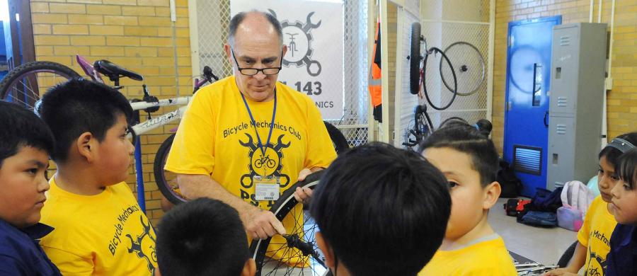 A man teaching bike repair