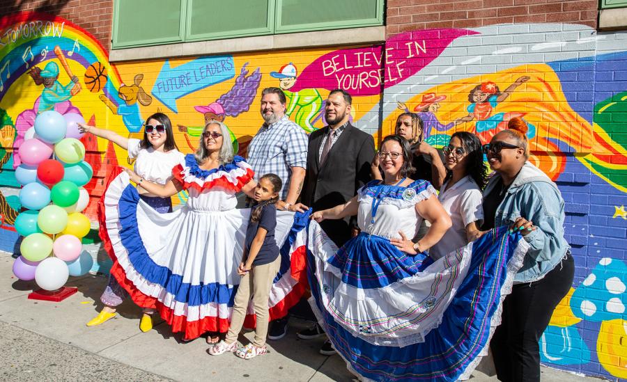  PS 18 art teacher Zoila Cordova (third from right), who serves on the school’s United Community Schools Advisory Board, and UFT Paraprofessional Representative Norma Ortega (second from left) wear festive dress honoring Hispanic Heritage Month. 