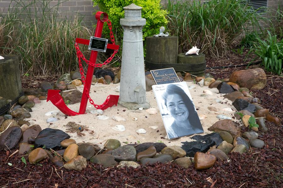 A plaque remembering Melissa Kruppa is part of the memorial garden for the COVID victim outside IS 24 on Staten Island.